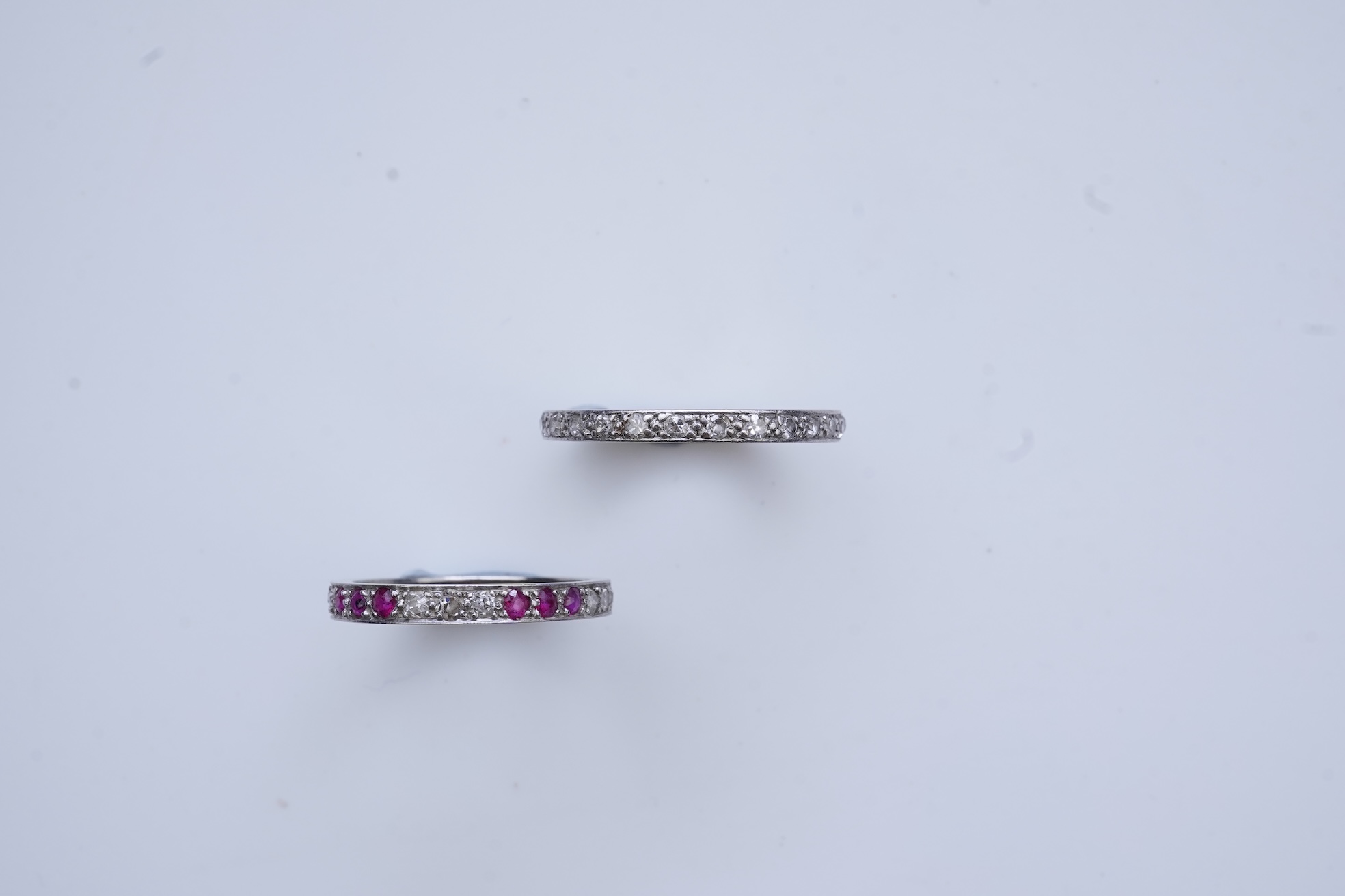 A diamond eternity ring and a ruby and diamond half eternity ring, mid 20th century